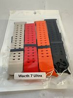 Sealed retail package showing four coloured watch straps