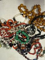 Pile of assorted bead necklaces and bracelets, various colours and materials