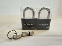 Front view of two padlocks in factory seal with keys displayed
