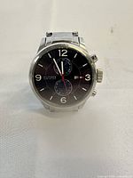 Front view of watch face showing dial, subdials and hands