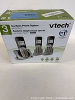 Front of VTech cordless phone system retail box showing three handsets and base