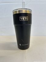 Front view of black YETI tumbler with straw lid