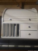 Front view showing roll-top, five mail slots, two drawers
