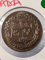 Obverse of copper medallion showing Canadian coat of arms