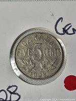 Obverse of 1928 Canada 5-cent coin inside holder
