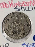 Close view of 1948 one-shilling coin reverse showing crowned lion and legends