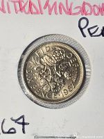 Close-up of 1967 six pence coin reverse in flip