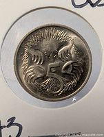Close view of coin reverse showing echidna around numeral 5