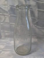 Full view of clear glass milk bottle