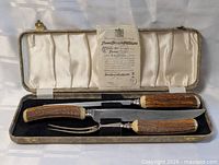Complete set in open case showing three pieces and guarantee sheet