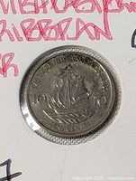 obverse of coin within flip, ship and denomination visible