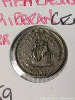 Reverse of 1959 British Caribbean Territories 10 Cents coin in holder