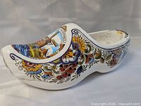 Left side view of ceramic Dutch shoe showing floral patterns and shape