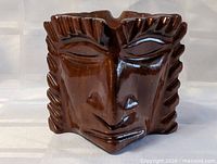 Front angled view of carved wooden Tiki face bowl