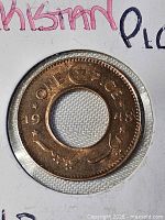 Close-up of obverse showing legend ONE PICE 1948 with crescent and star