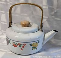 Full view of kettle showing bamboo handle and fruit graphics