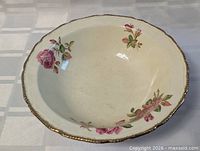 Top view of porcelain bowl showing floral design and gold rim