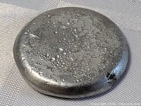 top view of pewter ingot showing cratered surface