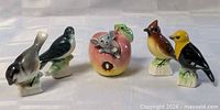 Group of five ceramic figurines: four birds and apple mouse