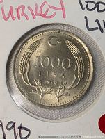 Reverse showing 1000 Lira, crescent, wheat, date 1990
