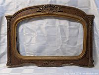 full front view of ornate arched wood frame