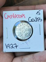 Obverse of 1927 Canada 5 cent coin in flip showing CANADA FIVE CENTS 1927