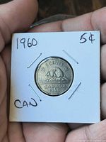 reverse of 1960 Canadian 5-cent coin in flip showing beaver design