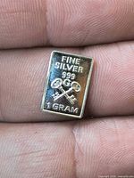 Obverse of silver bar showing text and crossed keys design