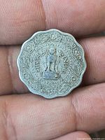 Obverse of coin showing Lion Capital and floral design