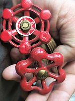 Front view of both valve stems showing red handles and brass bodies