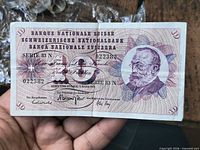 Obverse of the 10-franc banknote showing portrait, serial number, signatures and visible vertical fold