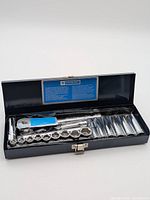 Open metal case showing ratchet, sockets and extensions