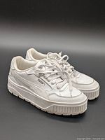 Oblique view of both sneakers showing uppers, laces, and platform soles