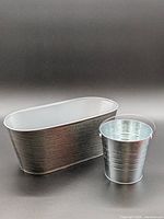 Round bucket and oval tub together