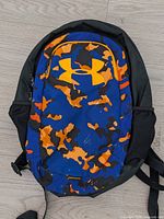 Front view of blue/orange camo Under Armour Storm backpack