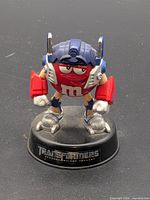 Front view of M&M's Optimus Prime figurine on base