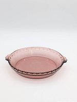 Top view of cranberry glass pie dish showing handles and fluted rim
