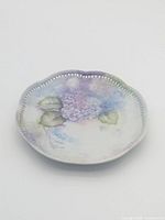 Full view of floral porcelain plate with pierced rim