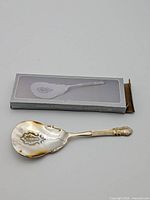 Full view of pastry server beside original box
