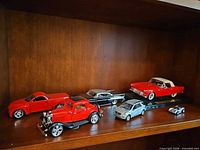 Shelf view of six model cars