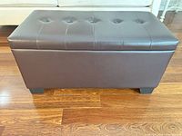 Ottoman closed showing tufted faux leather exterior