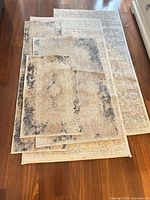 Stacked view of all five area rugs