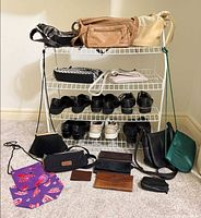 Overall lot showing shoe rack, handbags, shoes, wallets and accessories