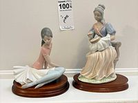 Both porcelain figurines displayed on bases