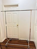 Full view of chrome rolling garment rack