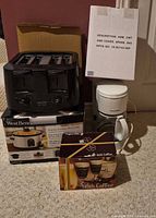 Group shot of all five items: toaster, slow cooker box, coffee maker, Keurig reservoir box, Irish Coffee glasses box