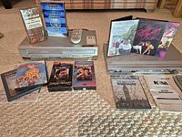 Overall view of both players, remotes, manuals, cleaning cassette, DVDs and VHS tapes