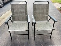 Front view of both grey folding patio chairs