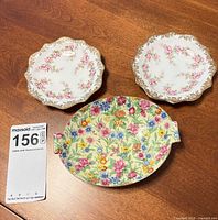 Group shot of two Dimity Rose saucers and one Royal Winton dish