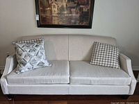 Front view of sofa with two seat cushions and two toss cushions